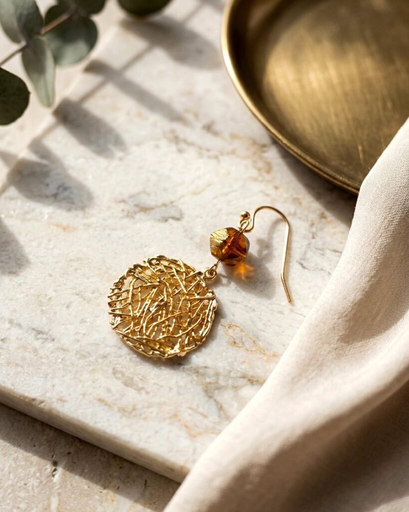 Handmade gold wire earrings with warm amber accent beads